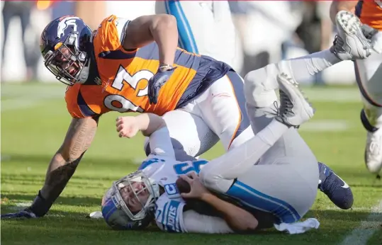  ?? JACK DEMPSEY/AP ?? Broncos defensive end Dre’Mont Jones sacks Lions quarterbac­k Jared Goff (24-for-39 passing for 215 yards) during the first half Sunday in Denver.