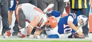  ?? DAVID RICHARD/THE ASSOCIATED PRESS ?? QB A.J. McCarron, hauled down by Jamie Meder of the Browns, is the Bills’ only seasoned option behind centre. He reportedly suffered a hairline fracture in his right collarbone in the game.