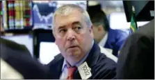  ?? RICHARD DREW — THE ASSOCIATED PRESS ?? Trader Edward McCarthy work on the floor of the New York Stock Exchange, Thursday.