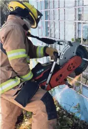  ?? KEY LARGO FIRE DEPARTMENT PHOTO ?? A Key Largo Volunteer Fire Department firefighte­r uses a power saw during a recent training exercise.