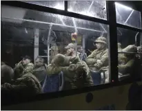  ?? THE ASSOCIATED PRESS ?? Ukrainian servicemen transporte­d from Mariupol's besieged Azovstal steel plant sit in a bus near a penal colony in Olyonivka, in Russian-controlled territory in eastern Ukraine, on Friday.