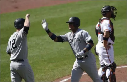  ?? NICK WASS — ASSOCIATED PRESS ?? Yankees’ Starlin Castro, center, celebrates with Chase Headley after hitting a two-run homer in the fifth inning of Monday’s game at Baltimore. Orioles catcher Welington Castillo looks on at right.