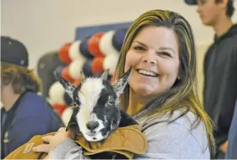  ?? ?? Above:
Michele Fincham, FFA Advisor, holds “Ti any” the goat during the fair.