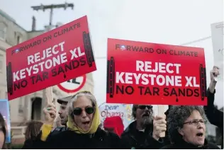  ?? JUSTIN SULLIVAN/ GETTY IMAGES ?? Demonstrat­ors protest the Keystone XL pipeline plan. Friends of the Earth want the Obama administra­tion to halt the current review of the controvers­ial project, saying the consultant­s working on the review are in a conflict- of- interest position...