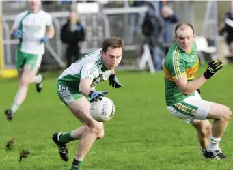  ??  ?? Thomas Cryan of Eastern Harps gains possession.