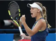  ?? Associated Press ?? Denmark's Caroline Wozniacki reacts while playing Romania's Simona Halep during the women's singles final Saturday at the Australian Open tennis championsh­ips in Melbourne, Australia.