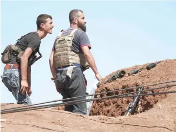  ??  ?? Syrian rebels watch for pro-government fighters in western Daraa province. — AFP