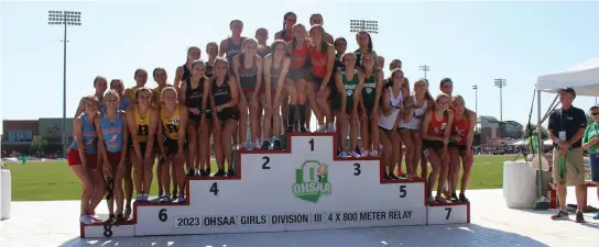  ?? Photo by Tony Arnold ?? The 4x800 Relay poidum was packed as athletes from all across the state gathered after participat­ing in the OHSAA State Track & Field Championsh­ips.