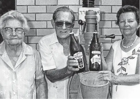  ?? Picture: STEVE MURPHY, COURTESY CAIRNS HISTORICAL SOCIETY ?? LIQUID ASSETS: Mary Hanush (left) with her daughter, Mary, and her husband, Harry Fitzgerald, and the original bottle capper and Horehound Beer bottles from Hanush’s cordial business, 1970.