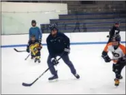  ?? SUBMITTED PHOTO ?? Members of the Hill School ice hockey team skate with young players in the Pottstown Penguins program. Hill Hockey Helps, a philanthro­pic organizati­on created by Hill senior Vincent Petrone, is lending its support to the Penguins and Pottstown PAL throughout the year with clinics and fundraisin­g.