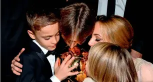  ?? AFP ?? Luka Modric (second left), his wife Vanja (right), his son Ivano and his daughter Ema kiss the trophy after the 2018 Fifa Ballon d’Or award ceremony. —