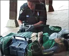  ??  ?? Victim: A paramedic helps one of the women at the scene