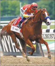  ?? Peter Morgan / Associated Press ?? Justify, with jockey Mike Smith up, crosses the finish line to win the 150th running of the Belmont Stakes and the Triple Crown on Saturday in Elmont, N.Y.