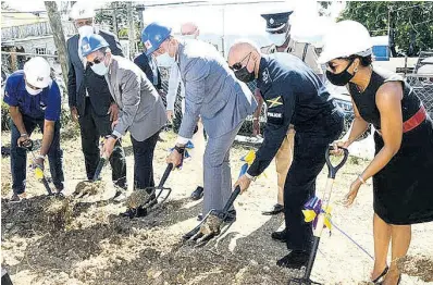 ?? FERGUSON PHOTO BY ALBERT ?? Prime Minister Andrew Holness (third right) and National Security Minister Dr Horace Chang (third left) break ground for the constructi­on of a new police station in Mt Salem, St James. Other persons in the photo are (from left) Omar Sweeney, managing director of the Jamaica Social Investment Fund; Dr Wayne Henry, chairman of the Jamaica Social Investment Fund; Major General Anthony Anderson, police commission­er; and Marlene Malahoo-Forte, attorney-general and member of parliament for St James West Central.
