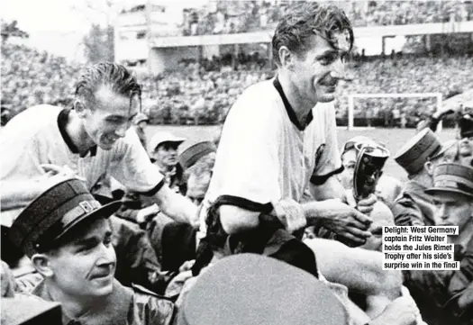  ??  ?? Delight: West Germany captain Fritz Walter holds the Jules Rimet Trophy after his side’s surprise win in the final