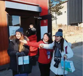  ??  ?? More visitors: Motoko Miyagi (centre) guiding tourists in Pyeongchan­g as the games take off.