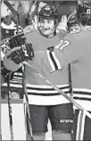  ?? JOHN J. KIM/CHICAGO TRIBUNE ?? Blackhawks defenseman Dennis Gilbert (39) celebrates with teammates after scoring a goal against the Islanders on Friday.