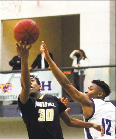  ?? Christian Abraham / Hearst Connecticu­t Media ?? Trumbull’s Timmond Williams lays up the ball as East Catholic’s Jaylin Hunter defends during Wednesday’s CIAC Division I state semifinal game in New Haven.