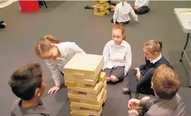  ??  ?? Students from St Joseph’s Primary School playing Jenga with questions in Ma¯ori written on the blocks.