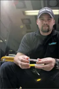  ?? The Sentinel-Record/Max Bryan ?? ADMINISTER­ED: Brandon Herron, a paramedic of LifeNet, holds a syringe of Narcan, a substance used for treating overdoses from Carfentani­l, an emerging opioid synthetic, and other opiods. LifeNet Hot Springs General Manager Jason Gartner said that an...