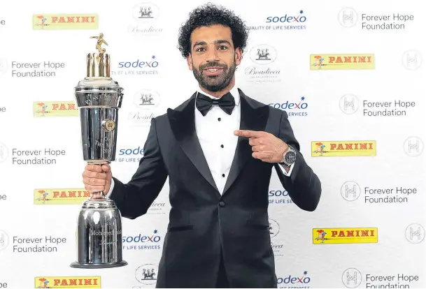  ??  ?? STAR MAN: Liverpool’s Mo Salah poses with the PFA player of the year award trophy