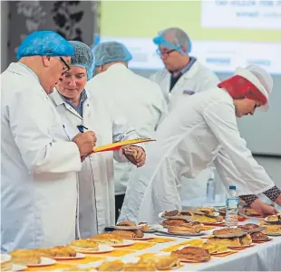  ?? Pictures: Steven Brown. ?? Around 50 judges helped to determine the world’s best Scotch pie by judging taste, shape, colour and evenness.