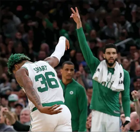  ?? MATT STONE — THE BOSTON HERALD ?? Marcus Smart of the Boston Celtics celebrates his 3-pointer with Jayson Tatum during the first half of Wednesday night’s victory over the Detroit Pistons at the TD Garden in Boston.