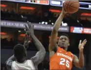  ?? TIMOTHY D. EASLEY — THE ASSOCIATED PRESS ?? Syracuse’s Tyus Battle (25) shoots over the defense of Louisville’s Deng Adel (22) during the first half, Sunday.