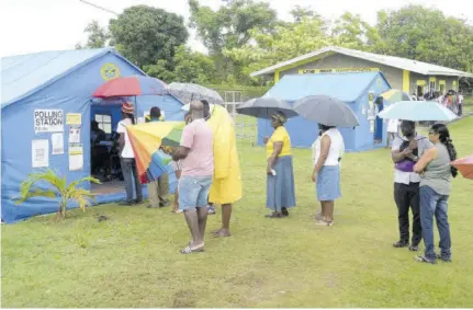  ?? ?? Jamaicans wait in line to cast their votes in a by-election in 2019.