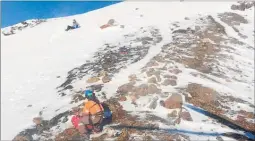  ?? Photo / Supplied ?? A Land Search and Rescue volunteer uses an ice axe and crampons to work his way across to a young Austrian woman stranded just below Red Crater. The woman’s companion fell 100m after slipping on ice.