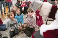  ??  ?? Reid Cook (front left), 4, and William Stafford (front right), 5, react to Judge Bedford’s magic tricks.