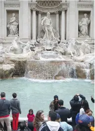  ?? JEFF J. MITCHELL / GETTY IMAGES ?? Millions of dollars in loose change, thrown every year into Rome’s Trevi Fountain by tourists, will now go to the city instead of Catholic Church charities.