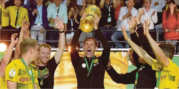  ?? EPA PIC ?? Dortmund head coach Thomas Tuchel lifts the German Cup at the Olympic Stadium in Berlin on Saturday.