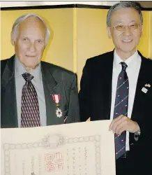  ?? CHRIS NELSON ?? Wally Ursuliak, left, is presented with the Order of the Rising Sun, Gold and Silver Rays medal by Kunihiko Tanabe, the consul general of Japan. Ursuliak helped introduce curling to Japan.