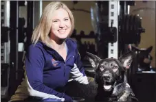  ?? Bob Luckey Jr. / Hearst Connecticu­t Media ?? Greenwich resident Amy Dixon, a triathlete who is blind, with her German Shepherd service dog Woodstock at Combine Training in Greenwich.