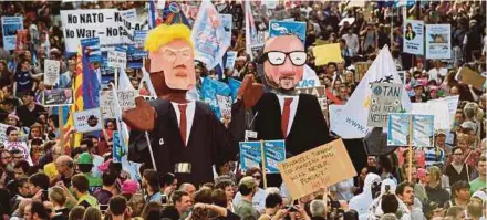  ?? AFP PIC ?? People carrying effigies of US President Donald Trump and Belgian Prime Minister Charles Michel during a demonstrat­ion against the US president in Brussels on Wednesday.