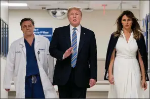  ?? AP/ANDREW HARNIK ?? Physician Igor Nichiporen­ko leads President Donald Trump and his wife, Melania, on a visit to school shooting victims Friday at Broward Health North hospital in Pompano Beach, Fla.