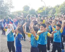  ??  ?? TETAMU kehormat bersama peserta larian sedang menyertai senamrobik sebelum memulakan larian.