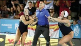  ?? SZILARD KOSZTICSAK — MTI VIA AP ?? Head coach Adam Krikorian of the U.S. is thrown into the water by his players after his team won the gold medal in the women’s water polo final match against Spain in Budapest, Hungary on Friday.