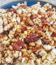  ?? PHOTO BY ANNE BRALY ?? Caramel corn is chock full of nuts and makes a great snack for football parties or a quiet night at home in front of the fire.