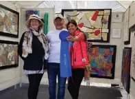  ??  ?? At the 2018 Hot Works Estero Fine Art Show , winning fiber artist K evin Kichar celebrates with Marianne Mege la, artist judge (left), and P atty Narozny, the event’s executive producer .