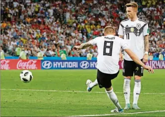  ?? FRANK AUGSTEIN / THE ASSOCIATED PRESS ?? Germany’s Toni Kroos, left, scores his side’s second goal during the group F match between Germany and Sweden Saturday in the Fisht Stadium in Sochi, Russia.