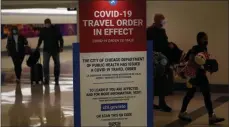  ?? CHARLES REX ARBOGAST — ASSOCIATED PRESS FILE ?? In a Nov. 24, 2020, photo, air travelers arriving at Midway Airport in Chicago are reminded of the city’s COVID-19 travel orders.