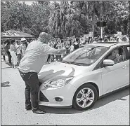  ?? AP/Miami Herald/C.M. GUERRERO ?? Demonstrat­ors block vehicles Wednesday outside a U.S. Immigratio­n and Customs Enforcemen­t office in Miramar, Fla., during a protest that called for abolishing the federal agency.