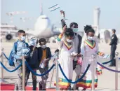  ?? SEBASTIAN SCHEINER/AP ?? Ethiopian immigrants wave Israeli flags as they arrive last year at Ben Gurion Airport near Tel Aviv.