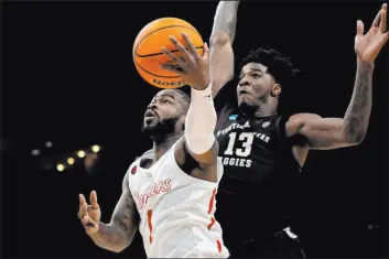  ?? George Walker IV The Associated Press ?? Houston guard Jamal Shead had 21 points and 10 assists as the top-seeded Cougars survived in overtime against Texas A&M.