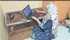  ??  ?? Kainat Naz, a former teacher who joined a programme to learn computer skills, works from home in Karachi.