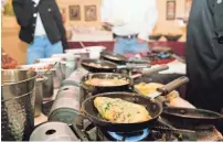  ??  ?? Rows of omelets cook July 18 at the brunch buffet at Owen Brennan’s in Memphis.