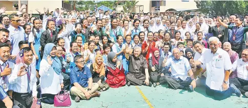  ??  ?? (Front row) Zahid (fourth right), Mahdzir (second right), Manyin (right), Dr Annuar (third left), Rakayah (second left) and others with students during their visit to SMK Rosli Dhoby.