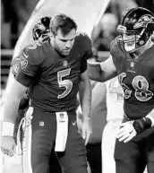  ?? ROB CARR/GETTY IMAGES ?? QB Joe Flacco, who took at hard hit in a game against the Dolphins, should be back for the Ravens this week.